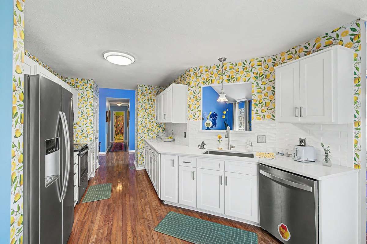 Not your old boring gray box the kichen shows its playful side with bright happy lemon wallpaper.