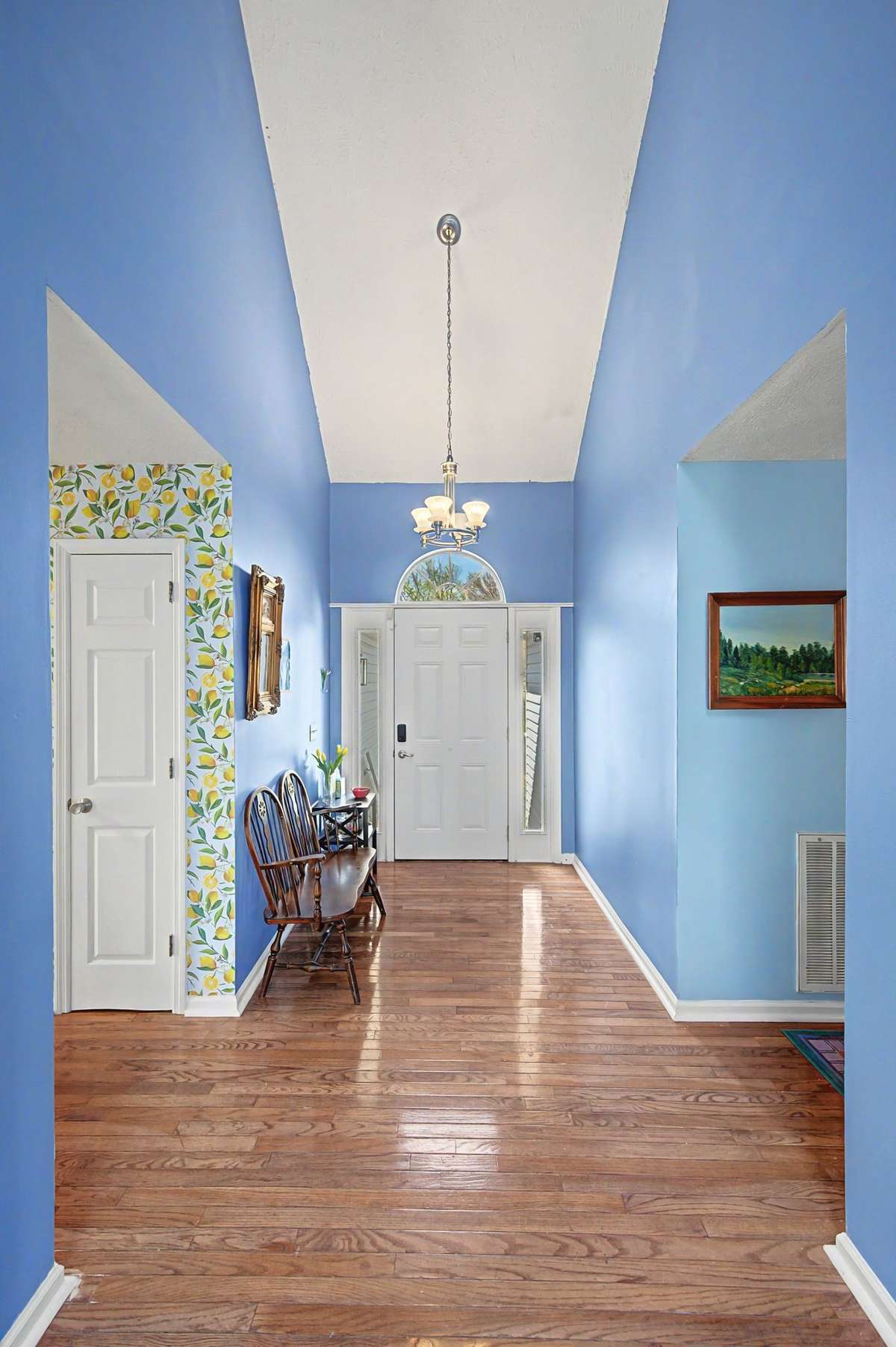 The front entry shows off the high ceilings and hardwood floors.