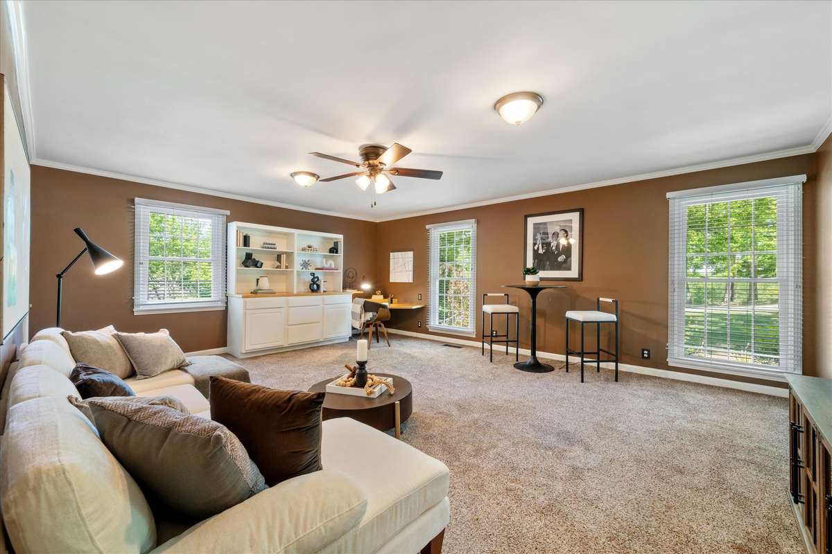 Main level bonus room has recent warmer toned paint and carpet.