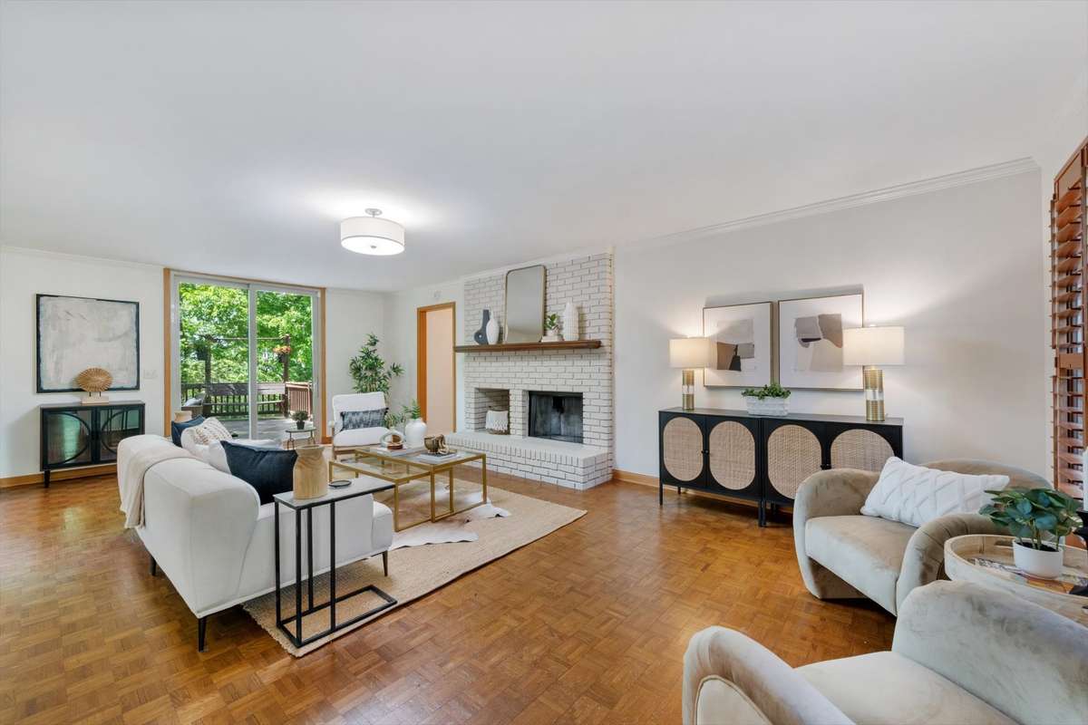 Spacious and bright den with brick fireplace. The paint on all walls, trim, ceilings and fireplace has been recently painted