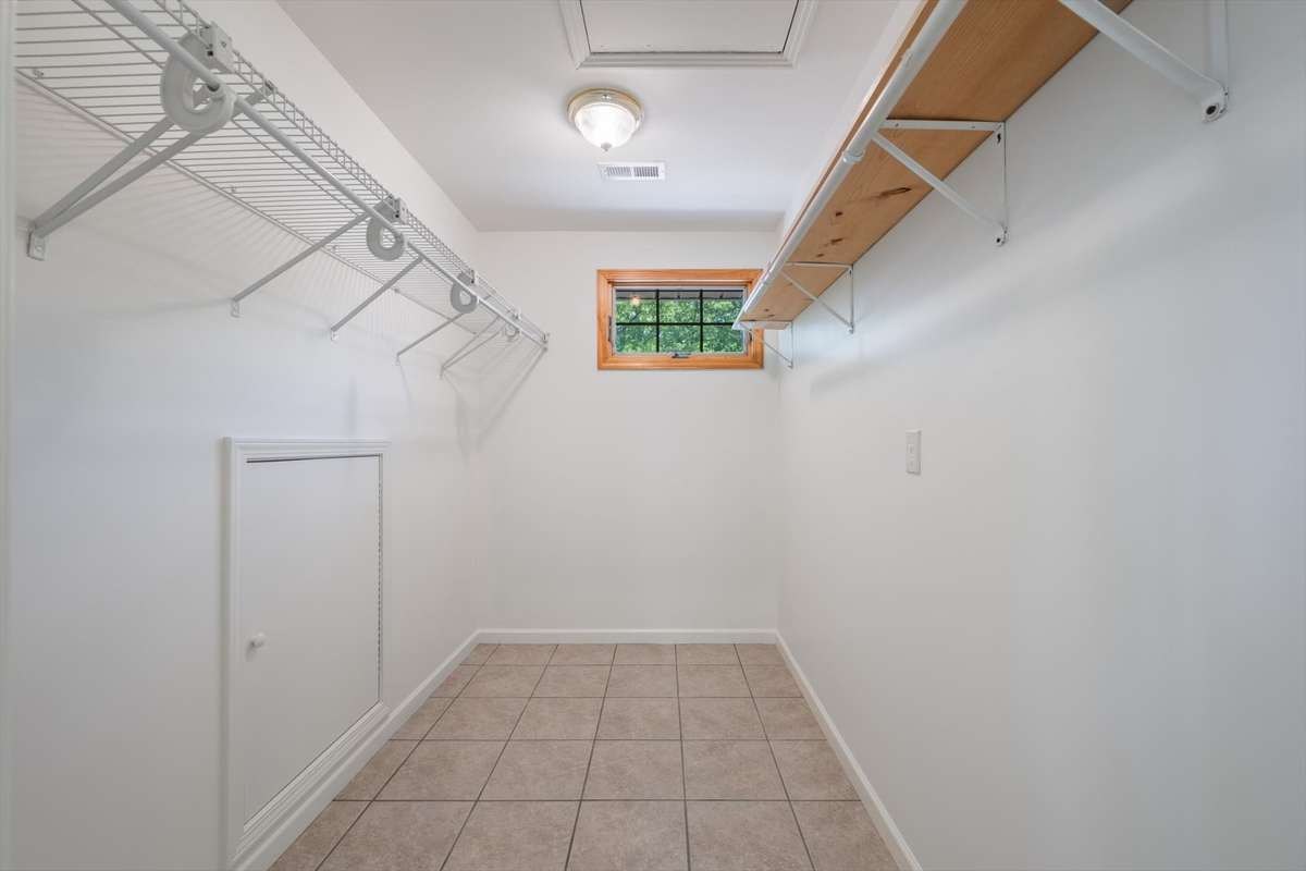 This is another large walk in closet in the primary bathroom. Pull down attic is here as well as the wall attic.