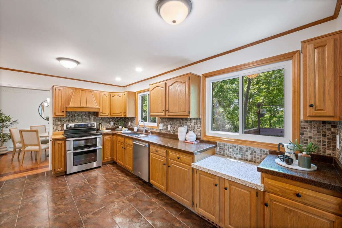 This wonderfully cool pass-thru window in the kitchen is perfect for entertaining when food can be served to those on the deck right from this sliding window.