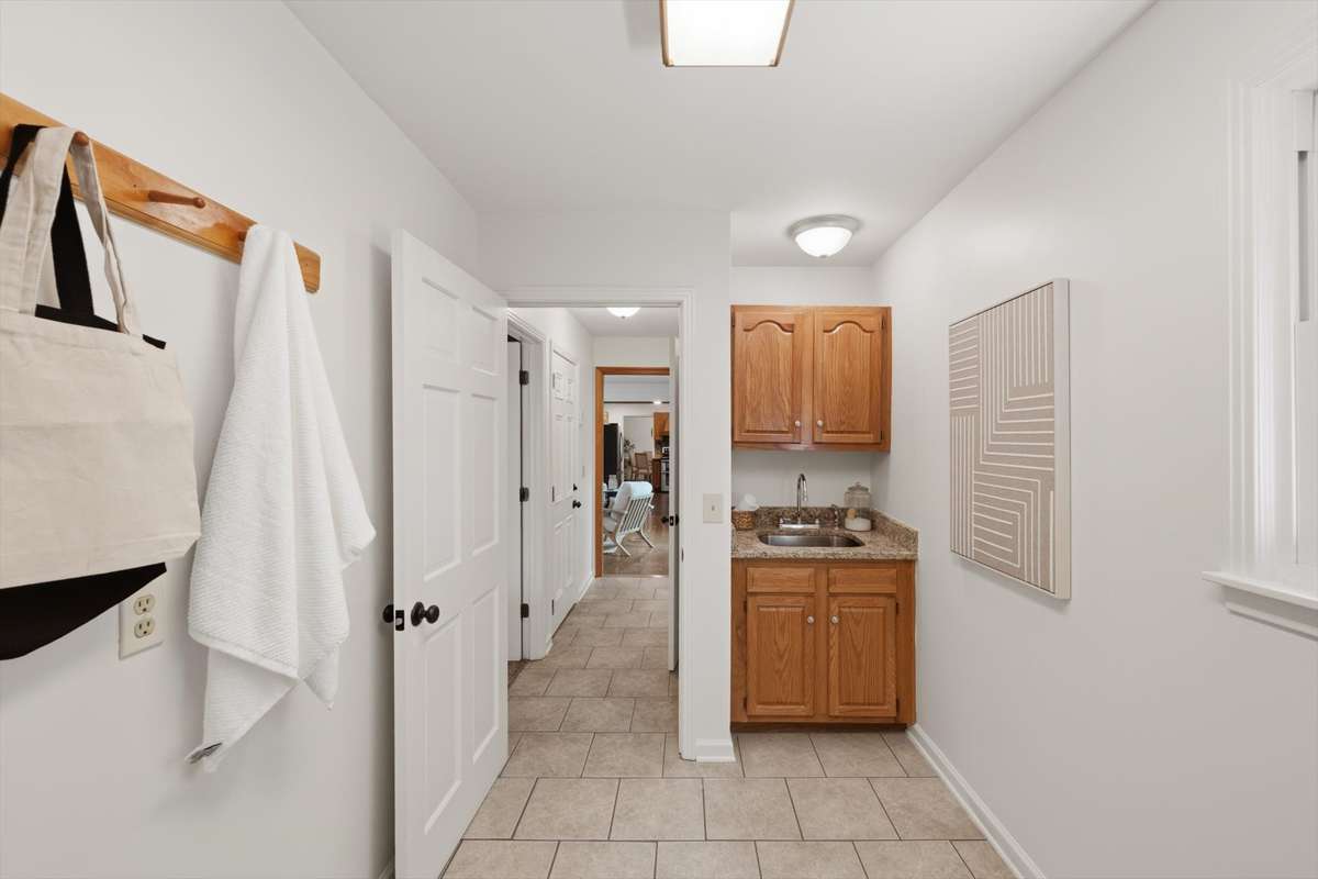 Laundry room with sink and cabinetry