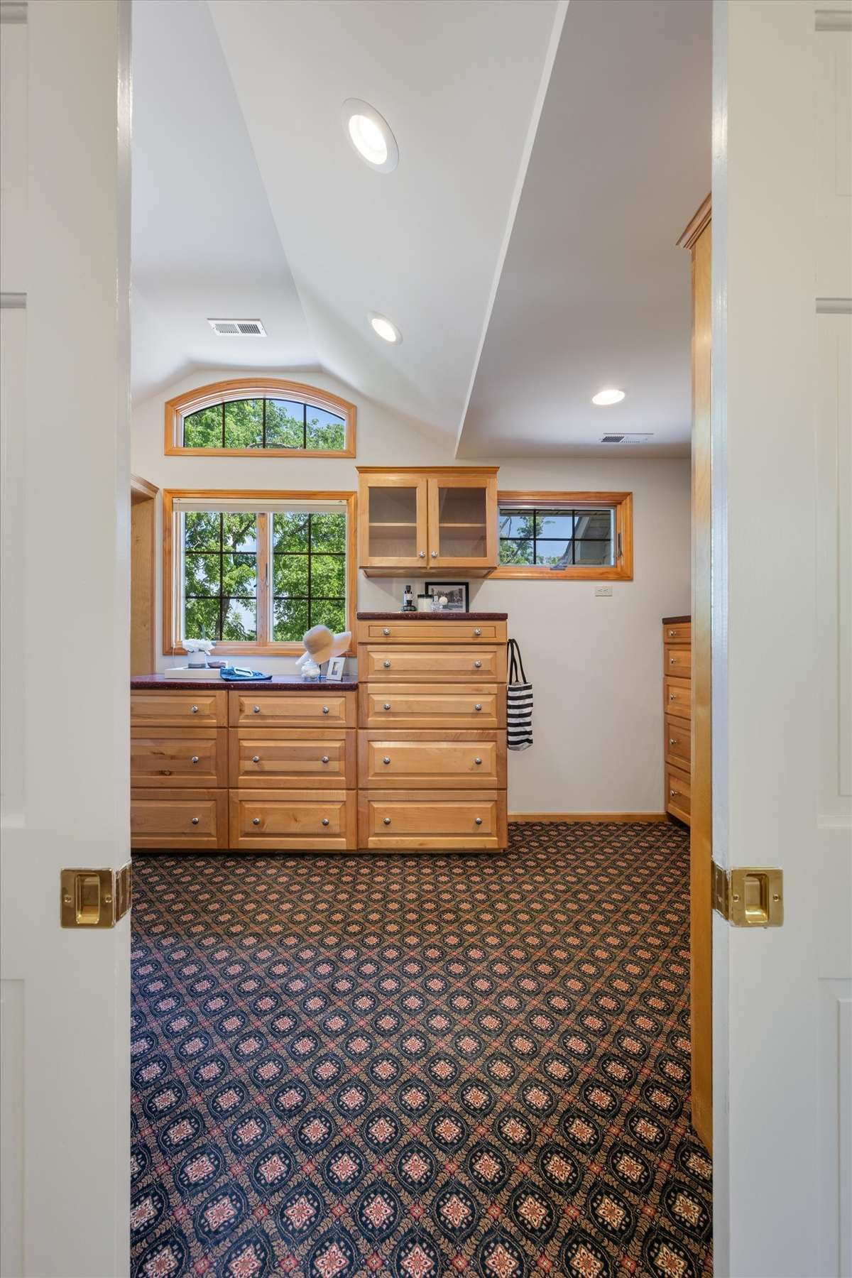 Welcome to the primary closet with pocket doors.