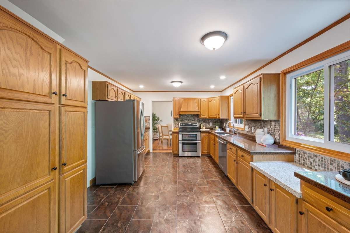 Recessed lighting in the kitchen as well as two flush mount lights bring great lighting during cooking.