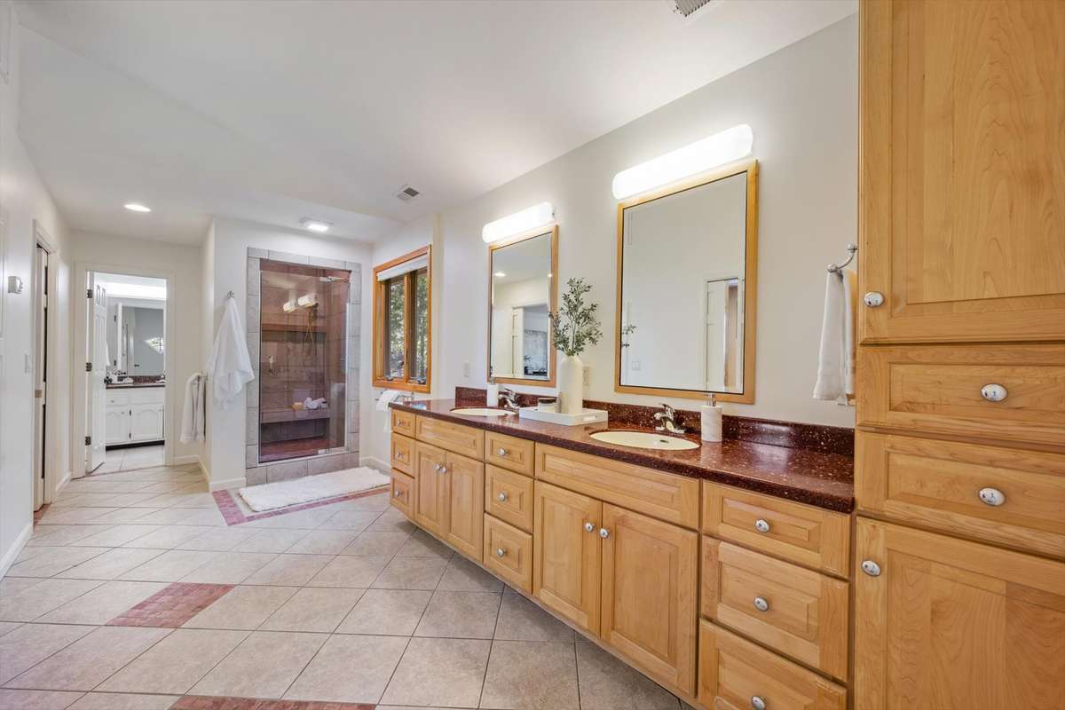 Across the room at the end is another vanity and water closet.
