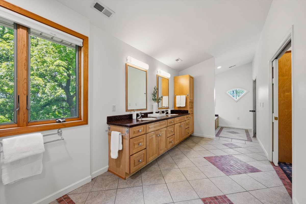 Welcome to the very large primary bathroom. So much space that no one is in the way.