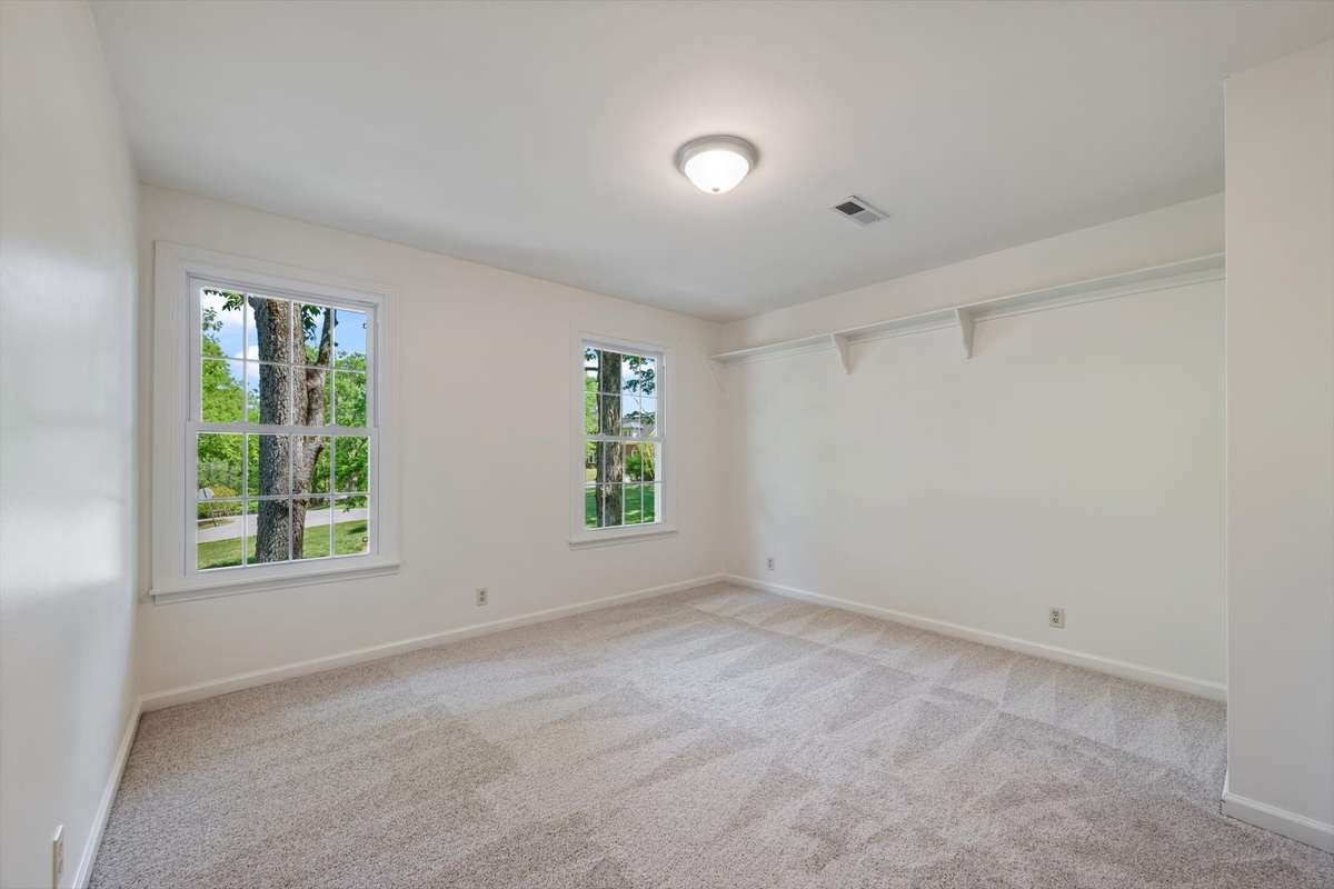 Secondary bedroom with built in ledge, front facing.
