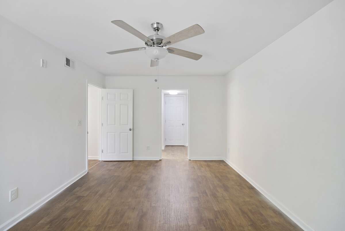 Another view of the Primary Bedroom, gorgeous flooring throughout and brand new ceiling fans!