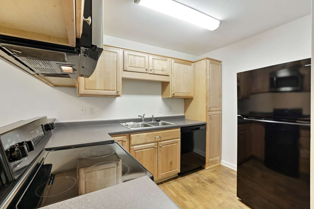 Neutral cabinets with plenty of storage, refrigerator stays! Lots of countertop space.