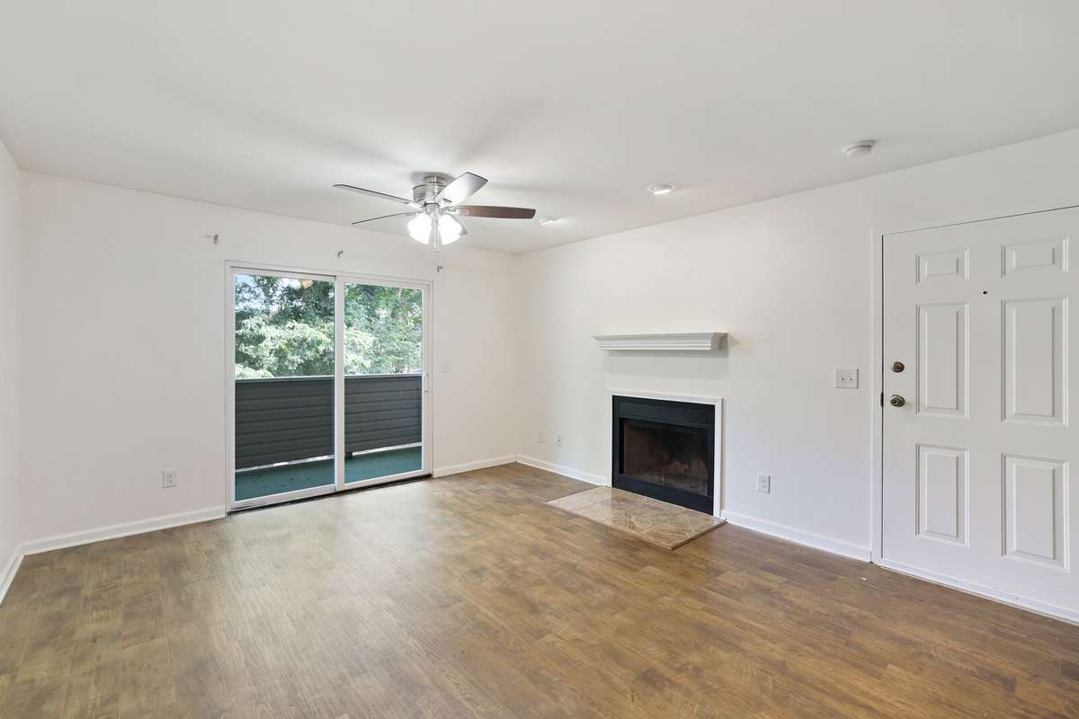 Living Room features a gas fireplace and brand new ceiling fan with a nice, private view from your balcony