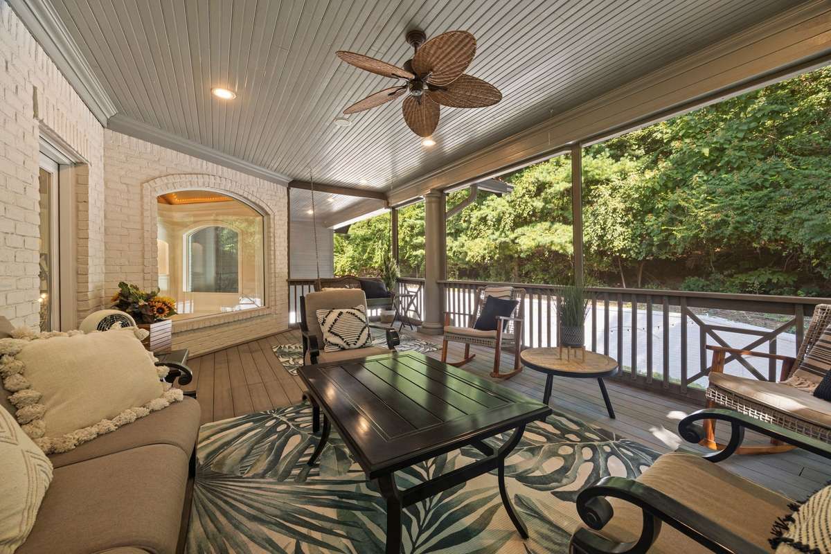 Relax on this screened-in private balcony looking over the patio and surrounded by lush greenery.