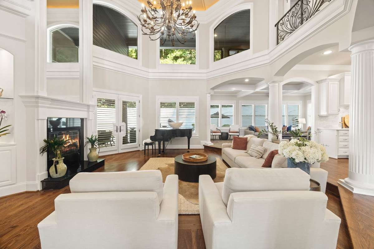 The Living Room dazzles with soaring ceilings, a cozy fireplace, retractable chandelier and refinished hardwoods.