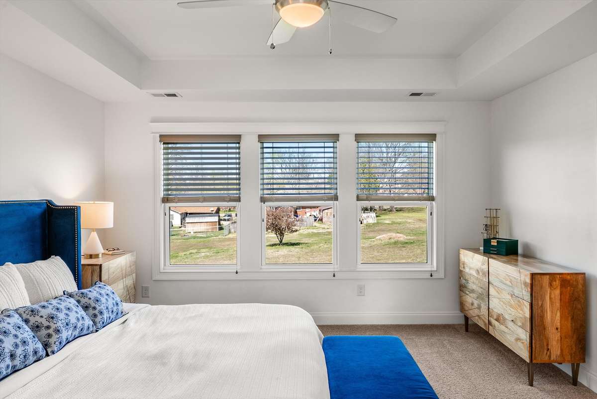 Luxurious primary bedroom with natural light and privacy