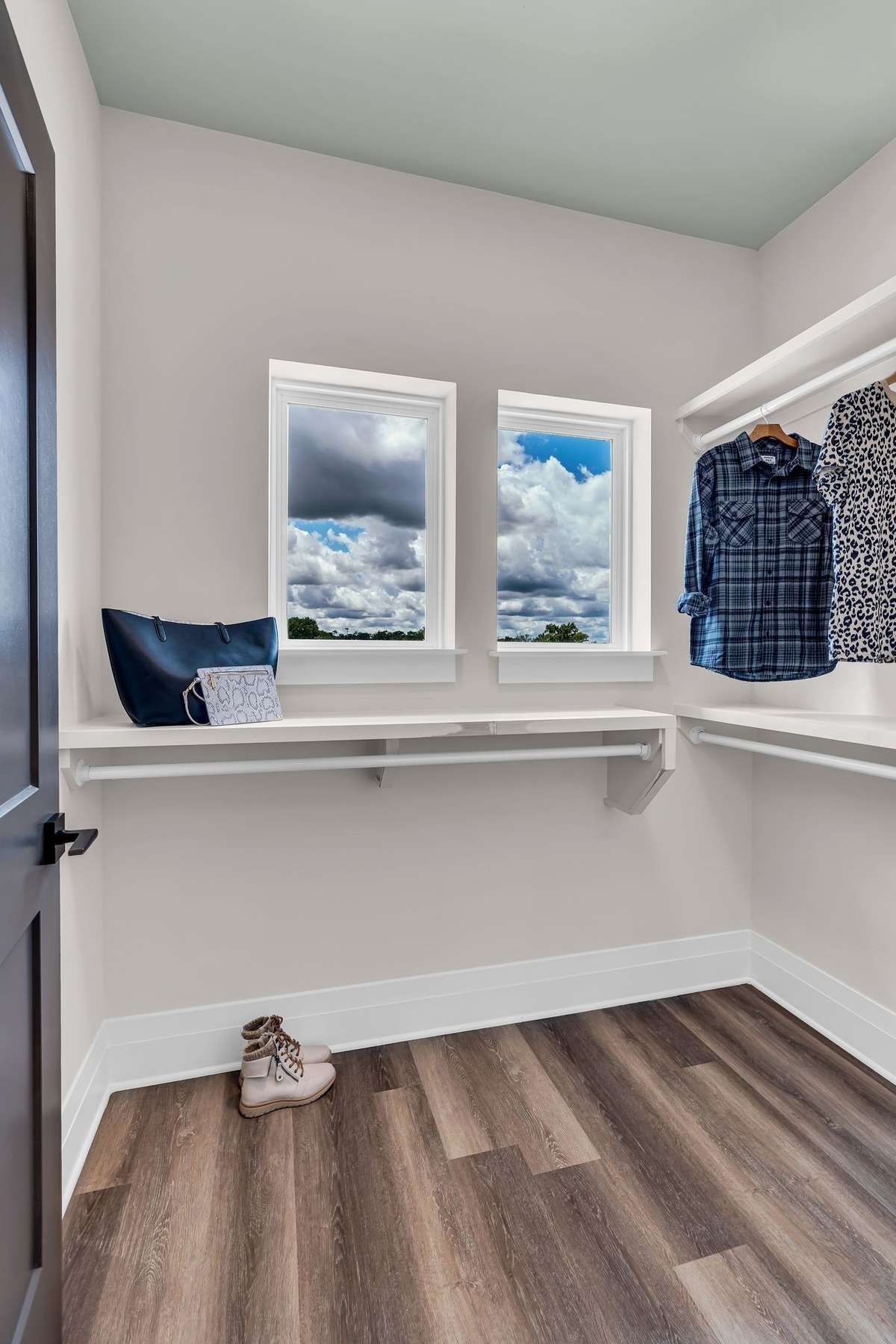 One of Two Closets in the Primary Bedroom with Custom Shelving.