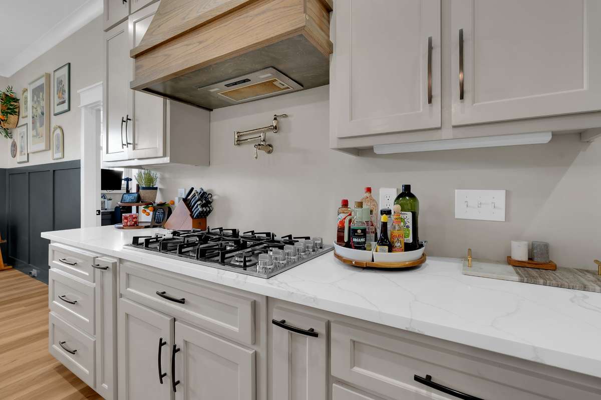 Beautiful tile backsplash, hot water dispenser, and large gas cooktop.  The gas tank is buried, and the utilities are underground