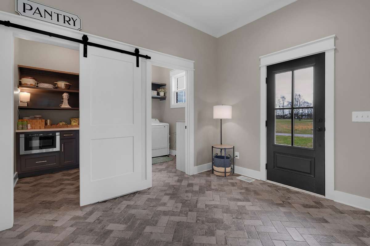 Barn door into butler's pantry, utility room and side entrancee