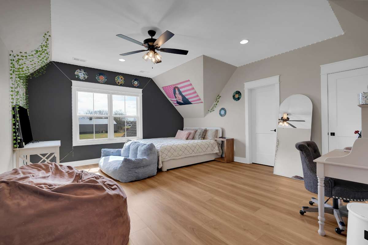 Bedroom 2 is huge with walk in closet with custom shelving, walk in attic storage and in it's own bath