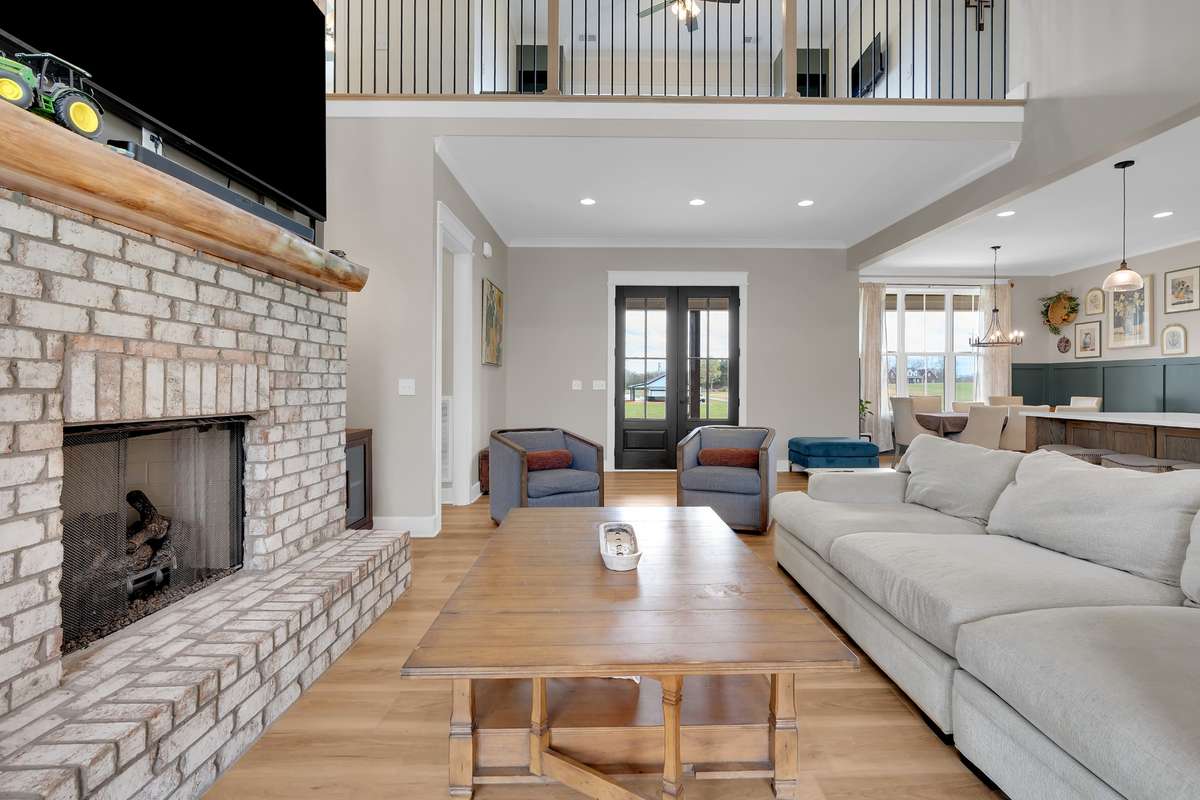 View toward the front door and loft upstairs
