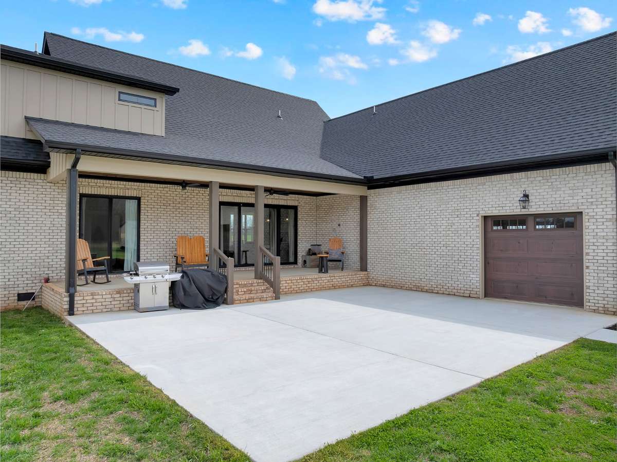 Large covered back porch and large patio for family gatherings and entertaining.
