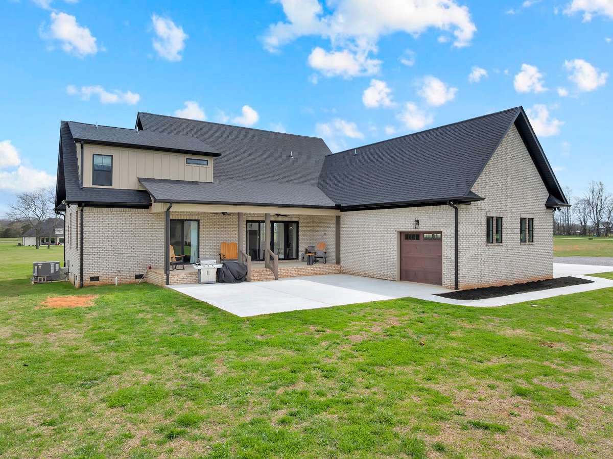Back of home with large covered porch and large patio for family gatherings or entertaining