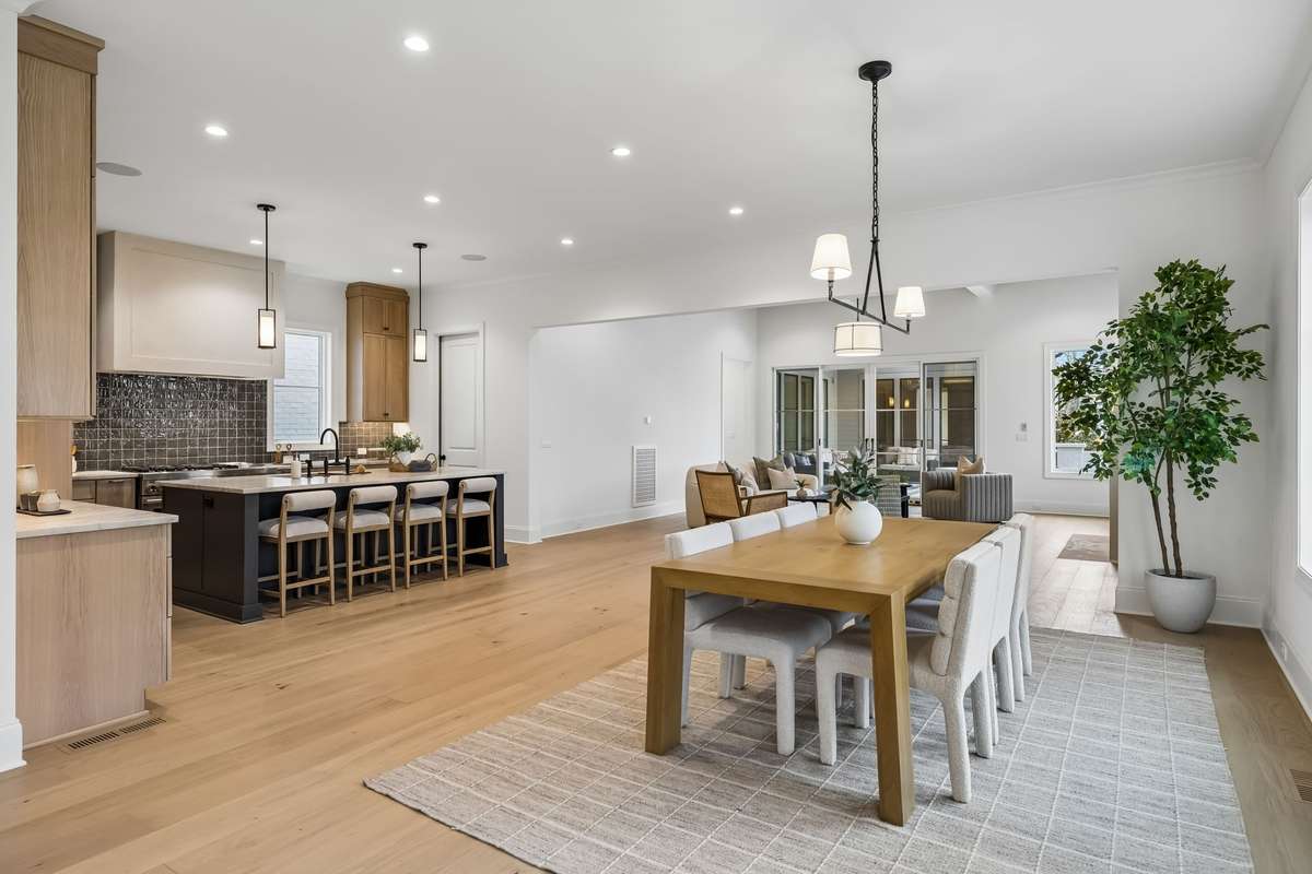 Beautifully designed for both everyday living and effortless entertaining, this open-concept space seamlessly connects the spacious dining room, designer kitchen, great room, and stylish wet bar foyer.
