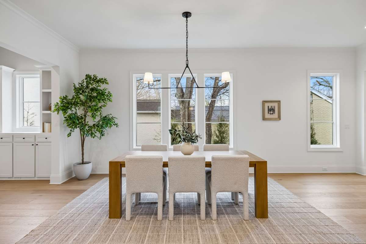 Beautifully designed for both everyday living and effortless entertaining, this open-concept space seamlessly connects the spacious dining room, designer kitchen, great room, and stylish wet bar foyer.