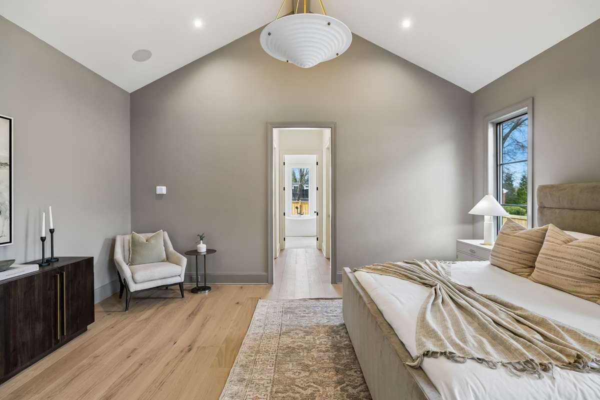 Serene primary suite with vaulted ceilings and abundant natural light, creating a calm, elevated retreat.