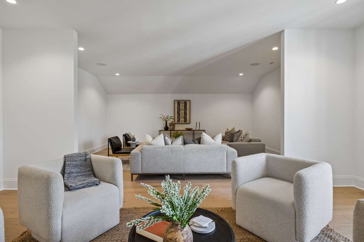 Bonus Room Three creates a cozy yet open retreat with abundant natural light and a comfortable seating area, ideal for a secondary living space, reading nook, or work-from-home setup. The thoughtful layout allows for separation of spaces