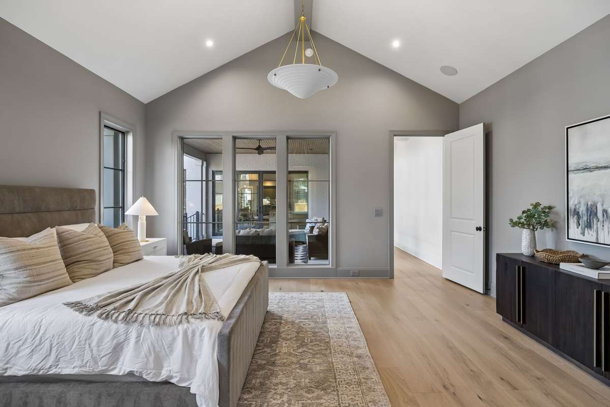 Serene primary suite with vaulted ceilings and abundant natural light, creating a calm, elevated retreat.
