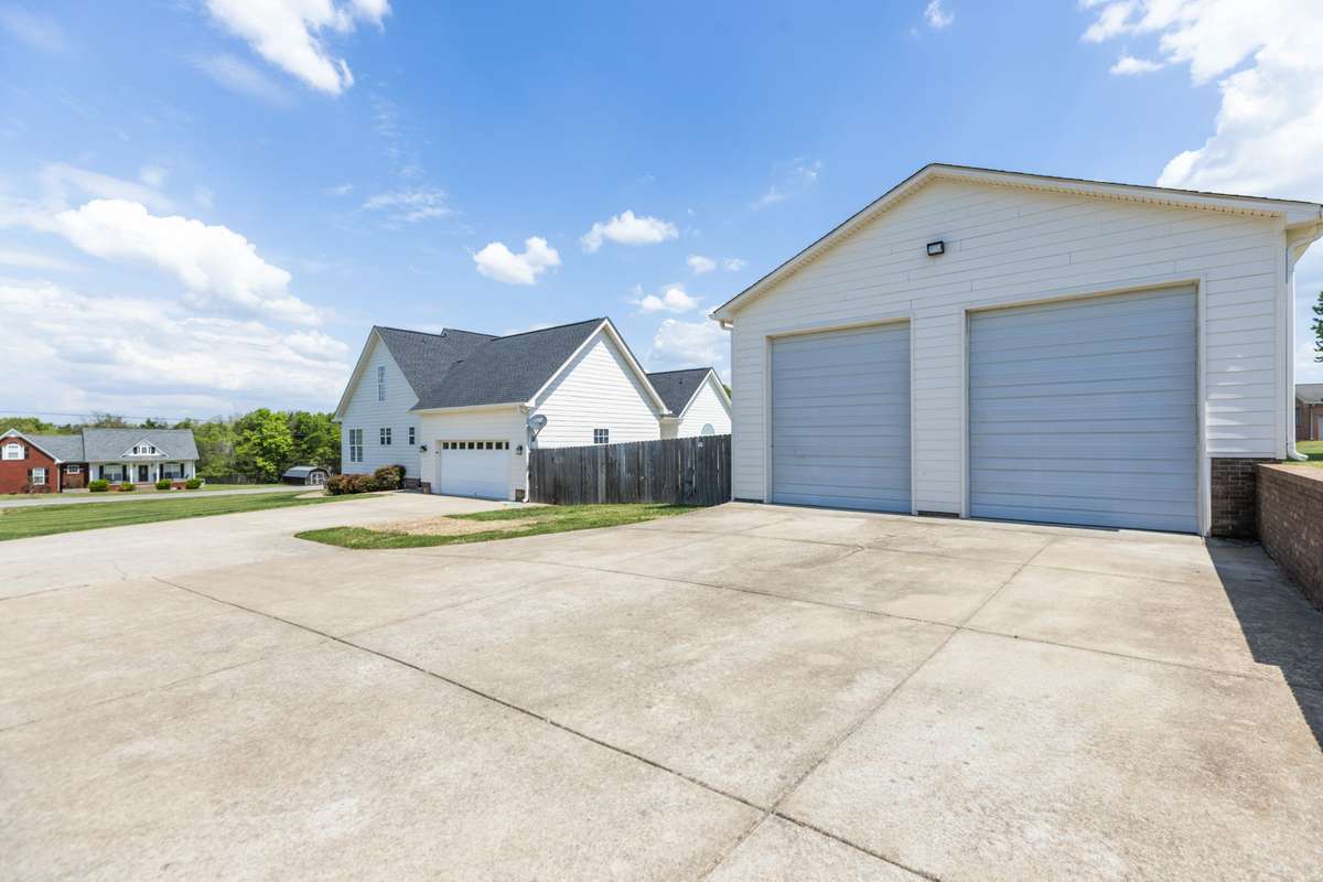 Detached Garage /Shop 28x40 with multiple 220V outlets  3 garage doors 2 front 1 back