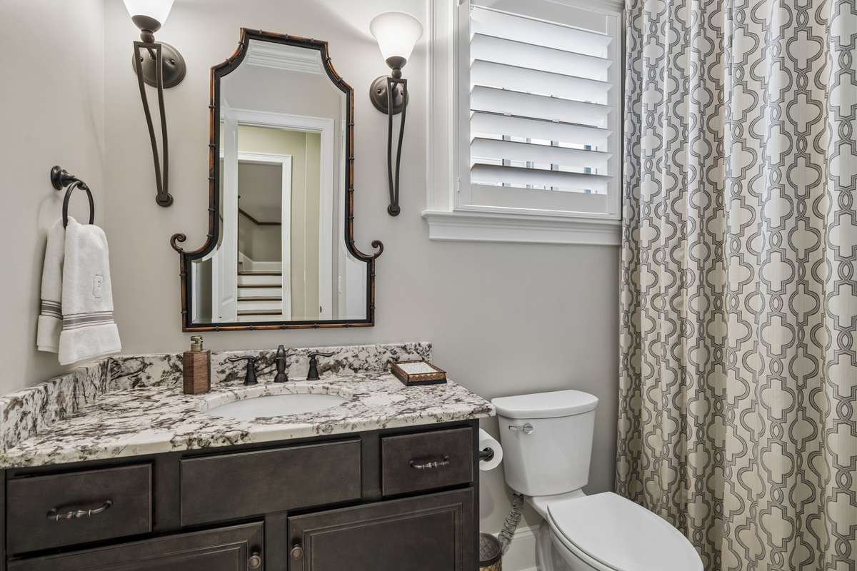 Full guest bath with custom shower curtain.