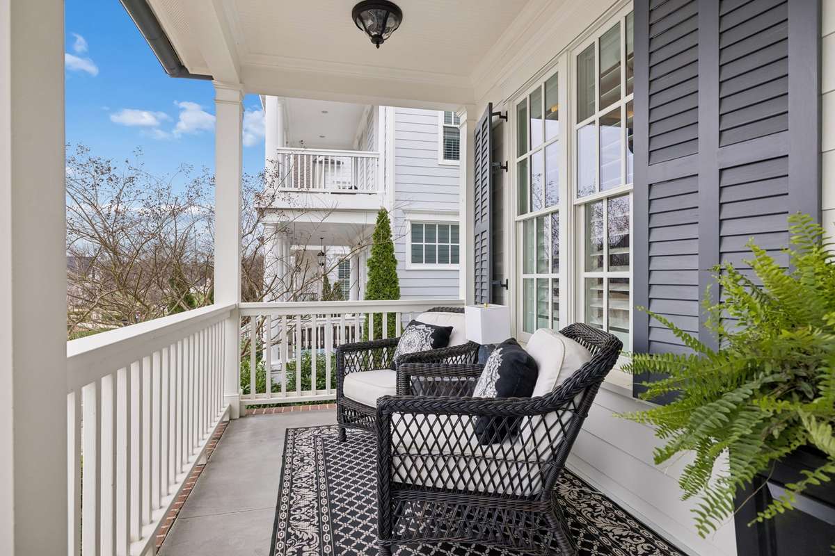 From the front porch, the view opens to manor lots across the street.