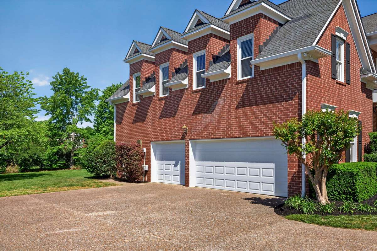 This view of the three-car garage showcases extra driveway space for additional parking