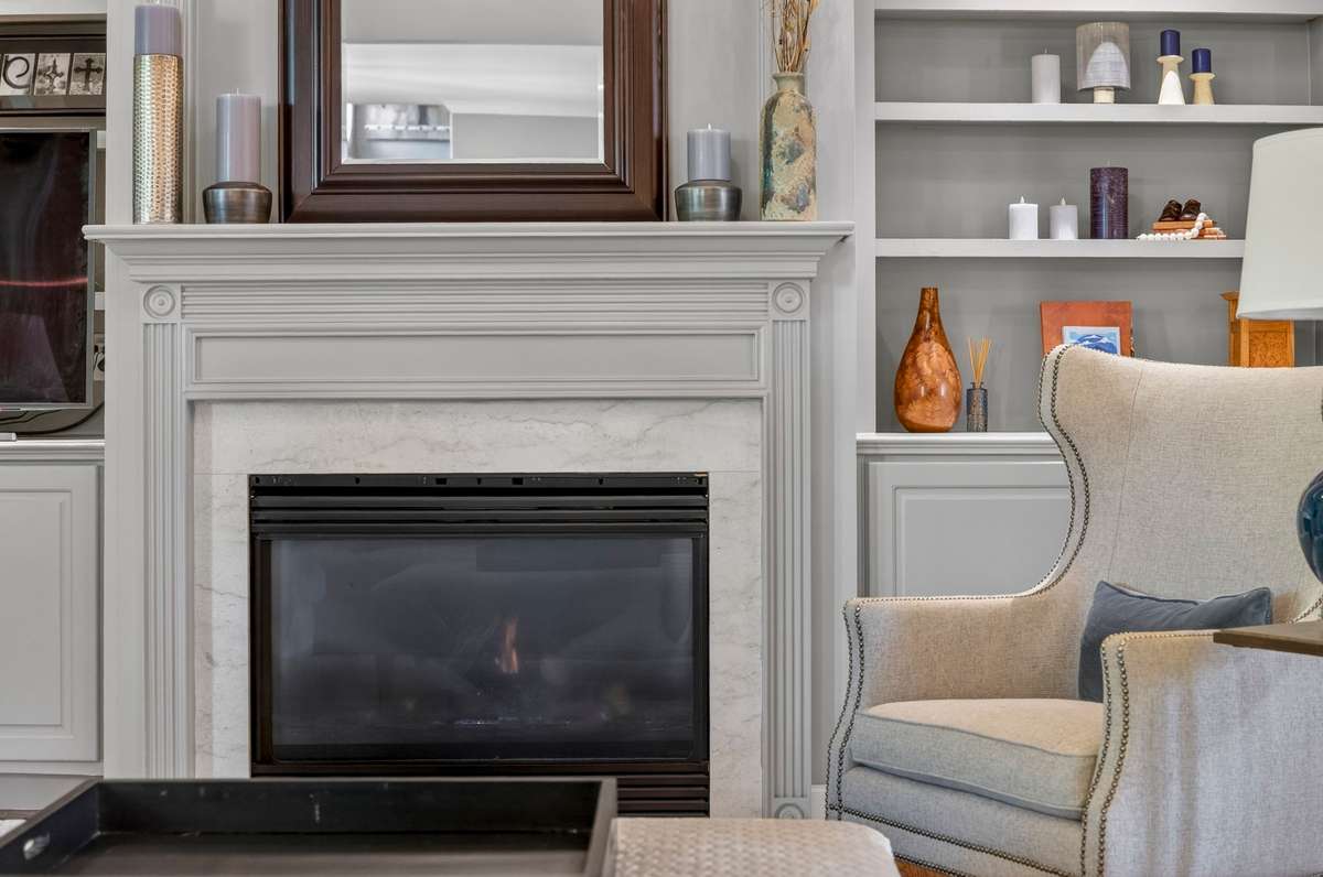 It's all in the details: a close-up of the built-in entertainment center showcases the beauty of a gas fireplace, custom bookshelves, and marble accents.