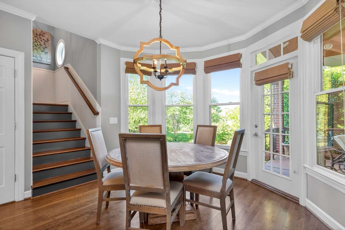 This inviting breakfast nook overlooks the private backyard, and grants access to the covered back porch. The back staircase access to the second level.