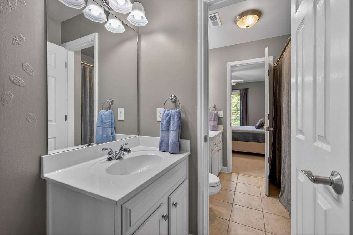 Bedroom two contains a half bath which connects to a full bath, each with its own closet space.