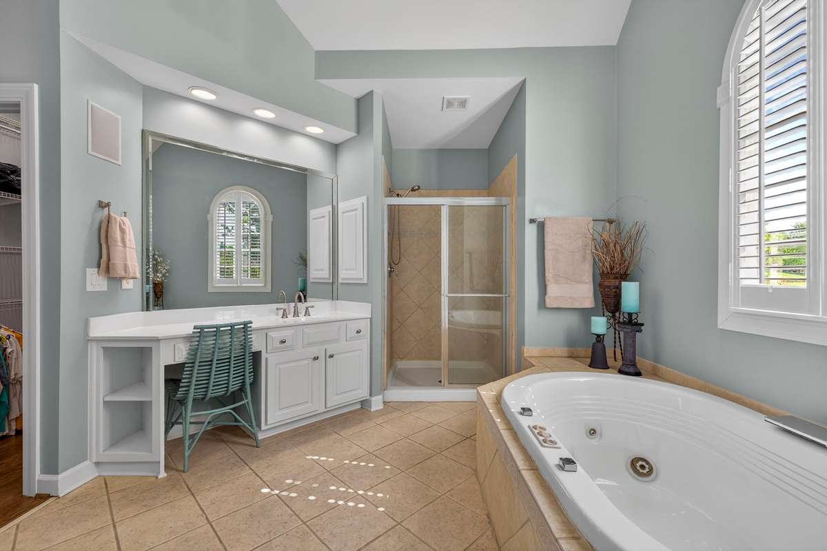 With double vanities and closets, a walk-in shower and soaking tub, this primary bath possesses endless potential.