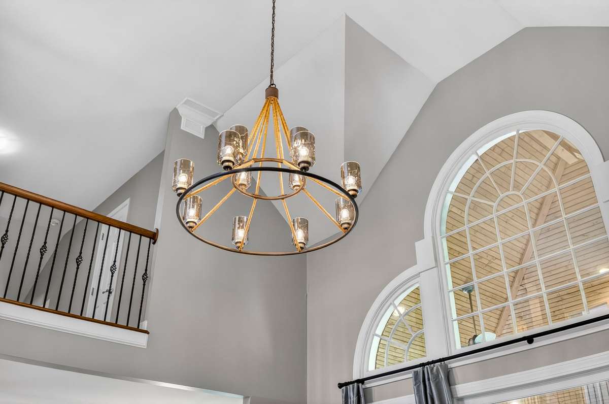 With vaulted ceilings and designer lighting, this showstopping great room is full of classic elegance