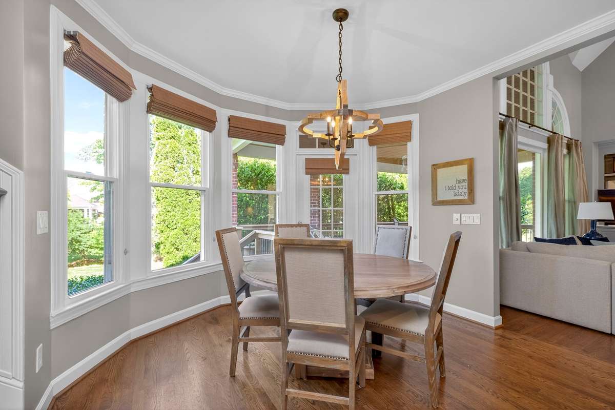 Designer lighting and crown molding accentuate the light-filled breakfast area
