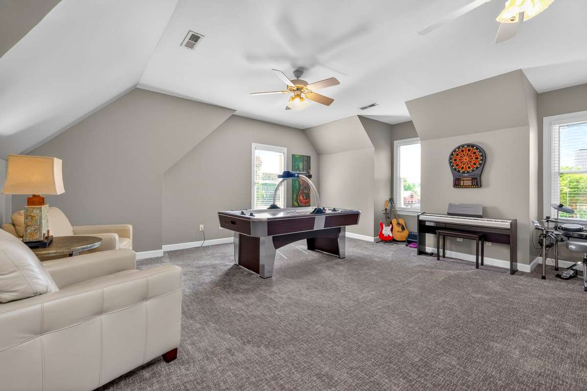 Staging accentuates the size and versatility of this bonus room, which can be used as a music room, game/media room, home gym, or play room.