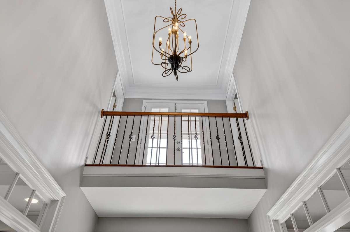 This skyward view of the foyer showcases the front balcony, which connects bedroom two and four.