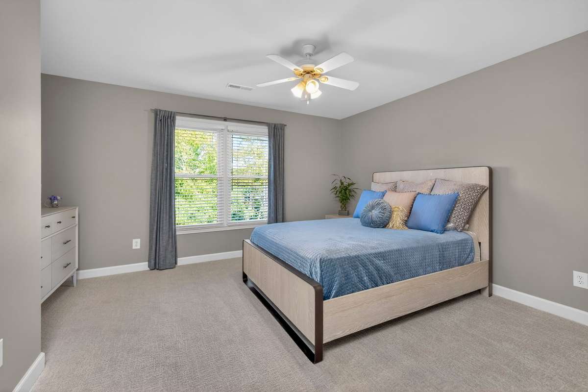 Bedroom three is spacious and offers a serene view of the backyard.