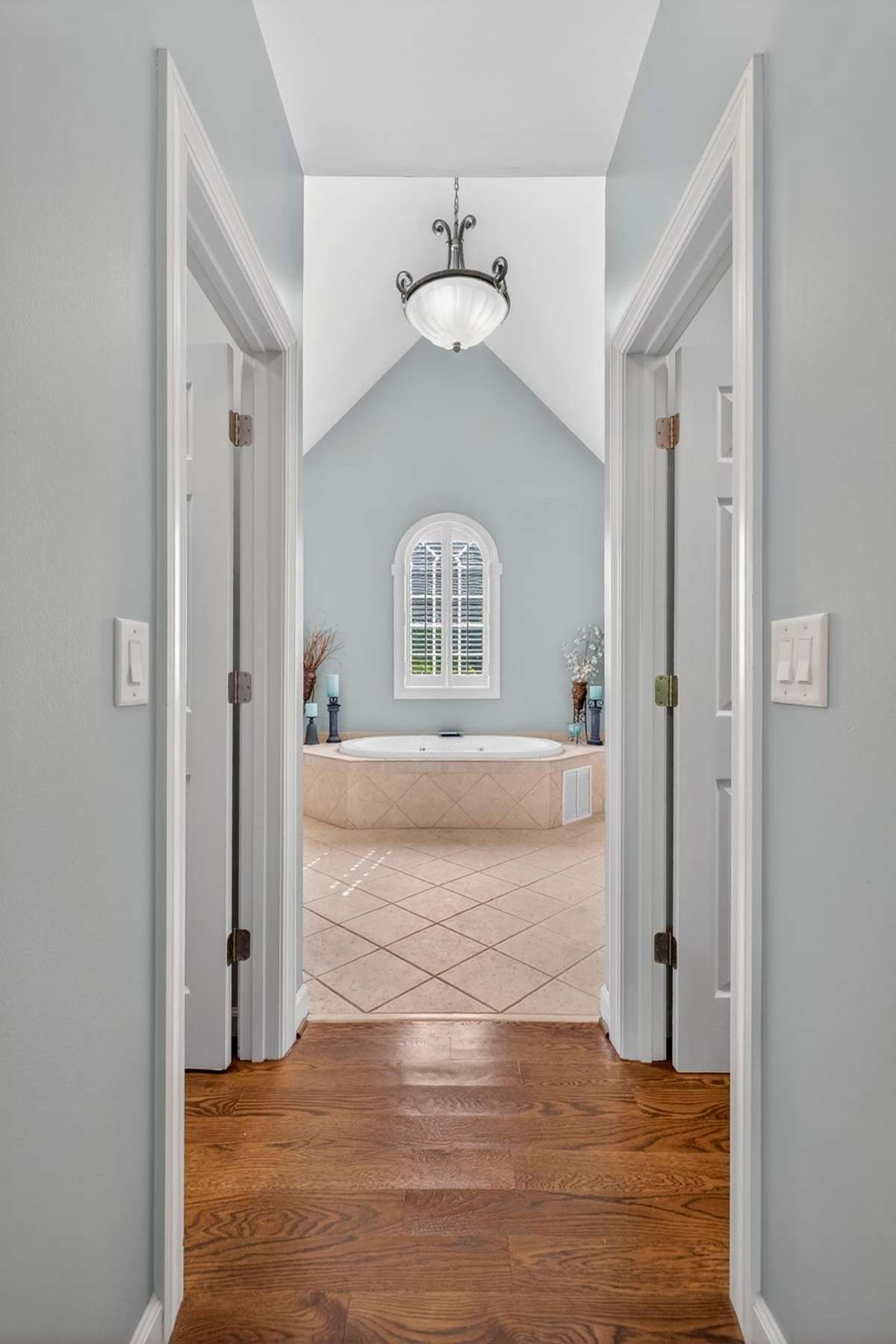 Connecting the primary bedroom to the spa-like bath, this hallway features double walk-in closets.