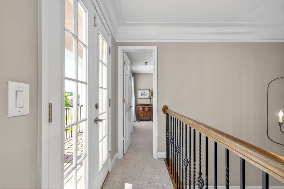 An upstairs walkway connects bedrooms two and four, granting access to the front balcony which overlooks the circular driveway.