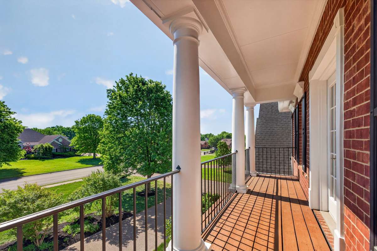 A set of french doors lead to the balcony which overlooks the front yard and circular driveway.