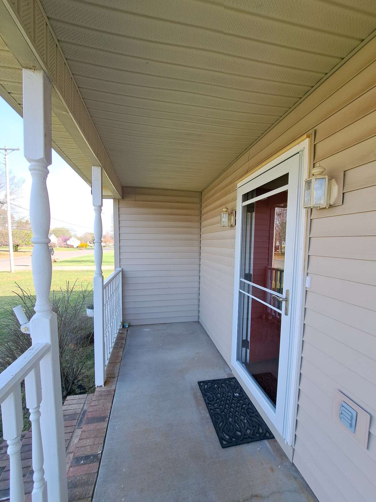 Flag holder on rail. A swing or rocking chairs will make this porch cozy!