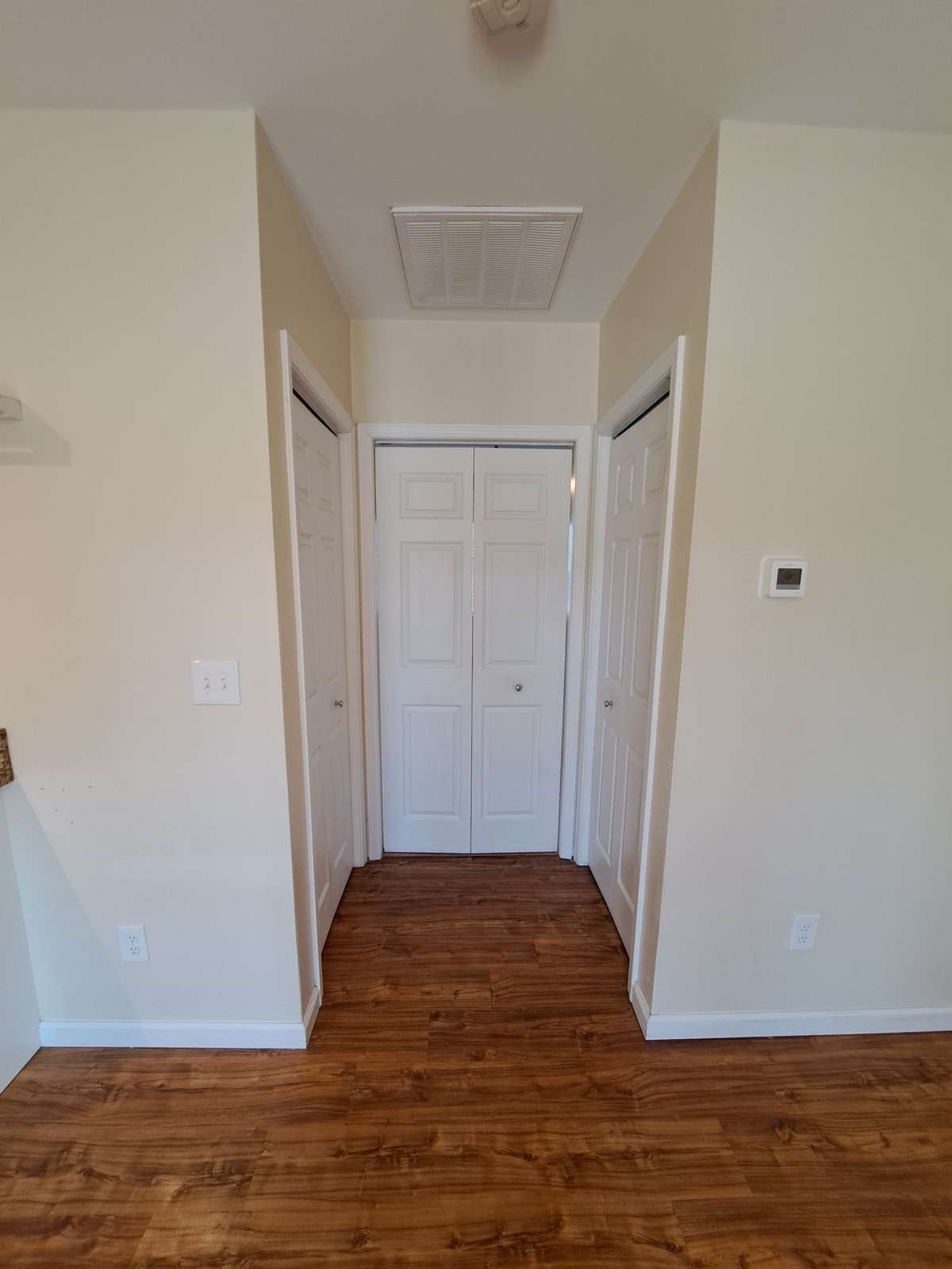 This closet is a large multi-purpose area for cleaning tools or storage.