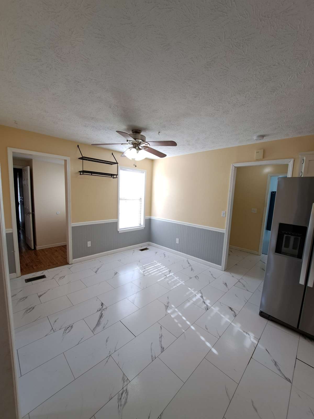 Spacious eat-in area. Door and hallway on left lead to the apartment and a door to the driveway.