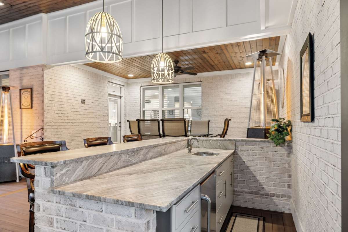 The bar also includes a beverage fridge and sink.